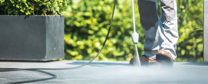 Worker power washing patio