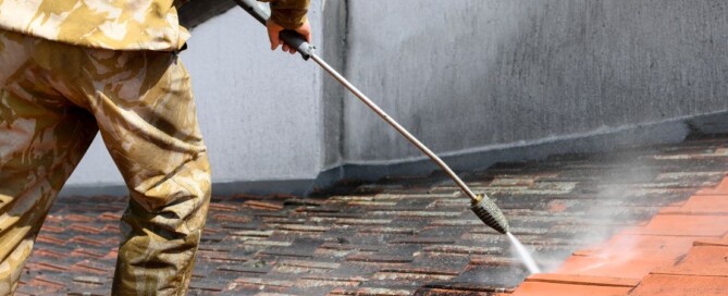 Worker cleaning roof